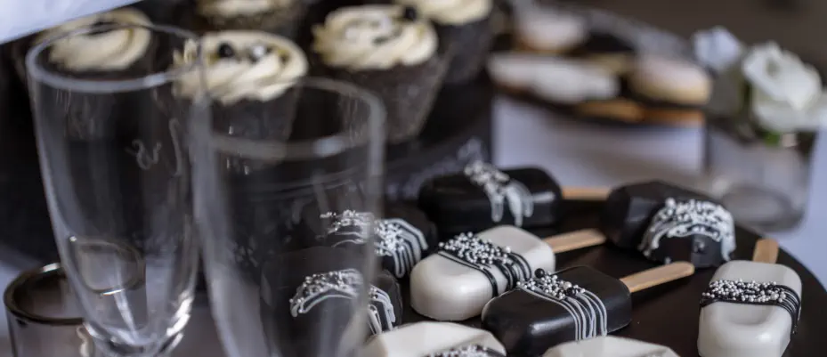 Delicate sugar flowers, meticulously crafted by hand, grace the wedding cake, enhancing its beauty and creating a luxurious ambiance